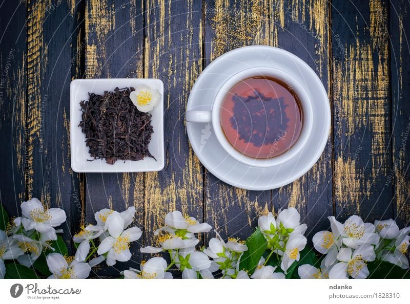 Tea cup and dry tea on wooden vintage table Herbs and spices Beverage Drinking Hot drink Table Plant Flower Leaf Blossom Wood Fresh Green Black White blooming