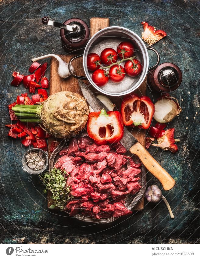 Beef goulash with vegetables and cooking ingredients Food Meat Vegetable Herbs and spices Nutrition Lunch Dinner Banquet Organic produce Crockery Pot Knives