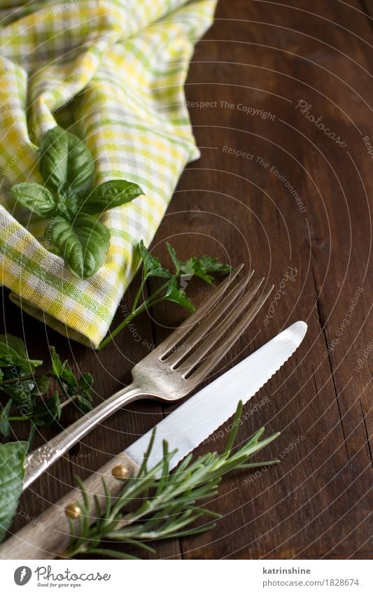 Vintage fork and knife on a colorful napkin Herbs and spices Dinner Cutlery Fork Table Places Old Dark Bright Retro Brown Yellow Green Arrangement Set tableware