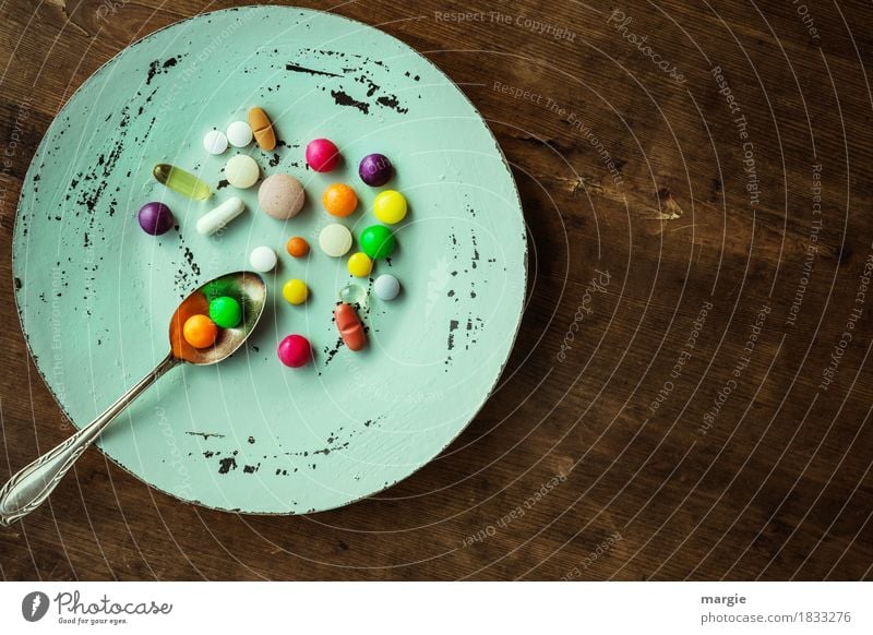 Colourful pills with tea spoon on a plate Nutrition Diet Fasting Plate Spoon pretty Healthy Illness Overweight Doctor Health care Brown Multicoloured Green Red