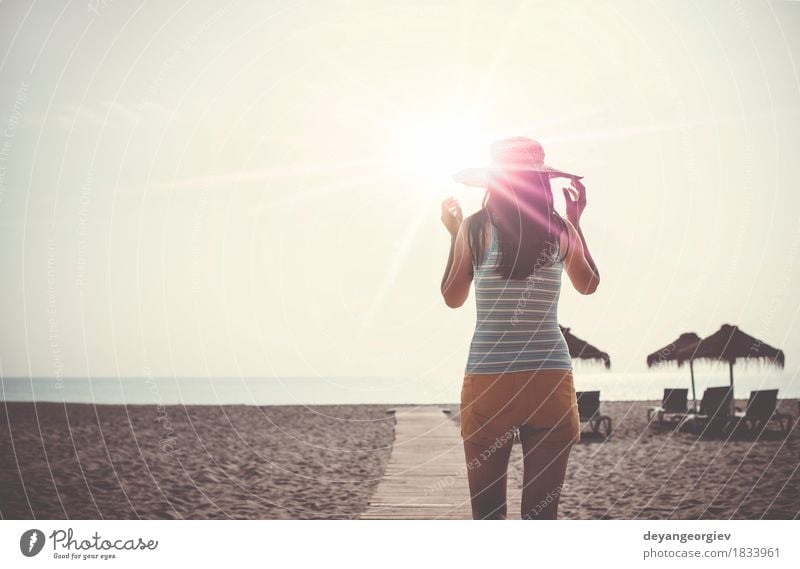 Woman with hat on wooden trail on the beach in the morning Lifestyle Happy Beautiful Relaxation Leisure and hobbies Vacation & Travel Summer Sun Beach Ocean