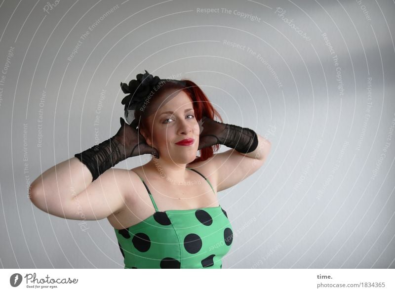 red-haired woman with black gloves in dotted dress, smiling and interlacing hands behind head Feminine Woman Adults 1 Human being Dress Accessory Jewellery