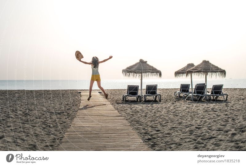 Wooden path to the beach, umbrellas and jumping woman Relaxation Vacation & Travel Summer Sun Beach Ocean Island Girl Woman Adults Nature Landscape Sand Sky