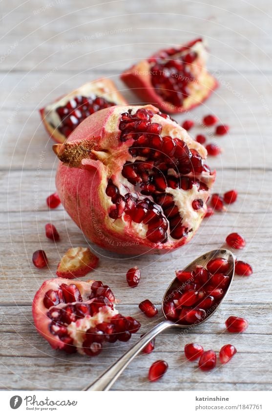 Open fresh ripe pomegranates Fruit Nutrition Vegetarian diet Diet Spoon Exotic Wood Fresh Delicious Juicy Brown Red agriculture antioxidant food Garnet healthy