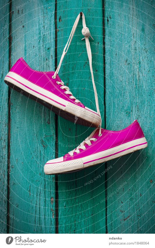 pair of bright pink sneakers hanging on a cord Style Design Fitness Sports Training Jogging Girl Woman Adults Man Couple Youth (Young adults) Feet Earth Fashion