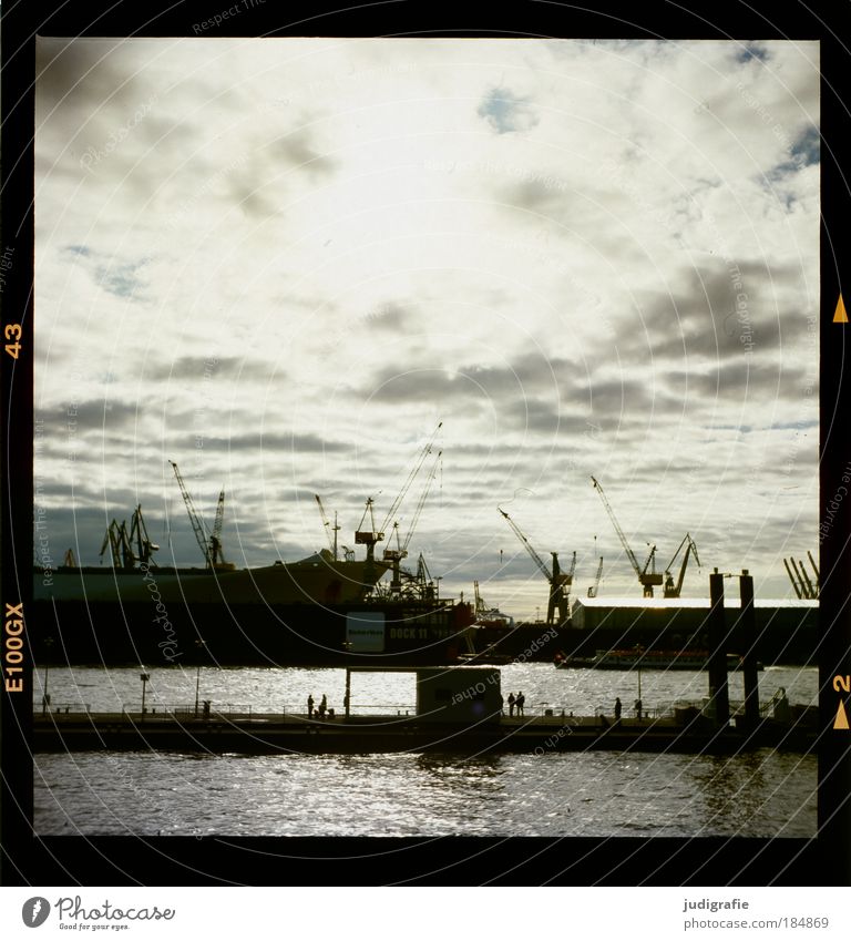 HAMBURG Colour photo Exterior shot Back-light Human being Sky Clouds Hamburg Town Harbour Navigation Inland navigation Container ship Dark Moody Tourism Economy