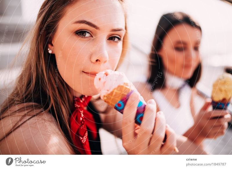 Girls eating ice cream on the promenade in summer holiday Dessert Ice cream Eating Lifestyle Joy Vacation & Travel Tourism Summer Summer vacation Sun Sunbathing