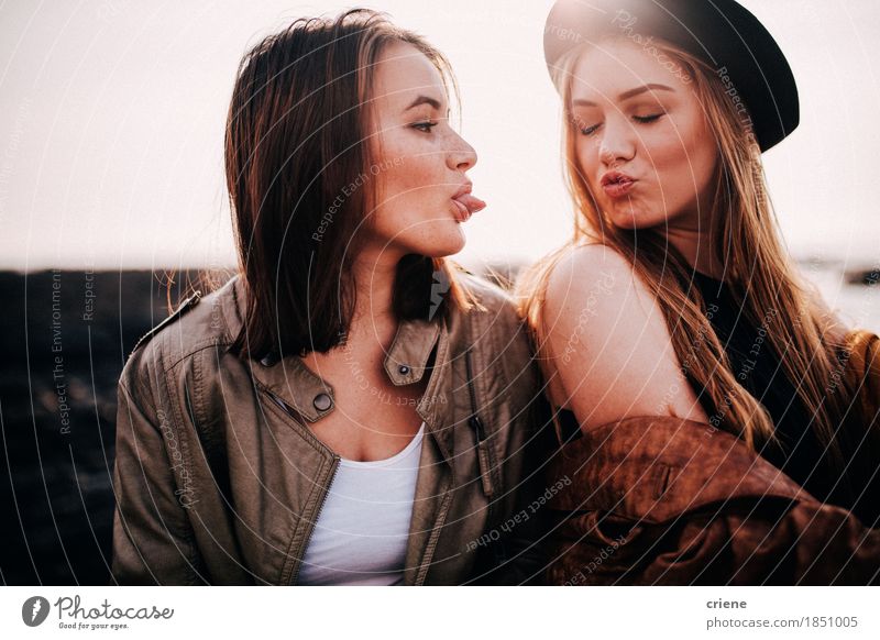 Two teenage girls having fun on beach pulling faces Lifestyle Joy Leisure and hobbies Beach Human being Young woman Youth (Young adults) Woman Adults Sister