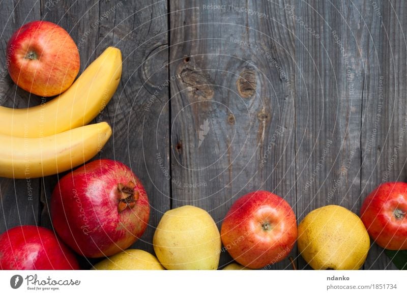 fruit on wooden background: banana, apple, pear and pomegranate Food Fruit Apple Vegetarian diet Lifestyle Autumn Wood Fresh Juicy Gray Banana Edible frame