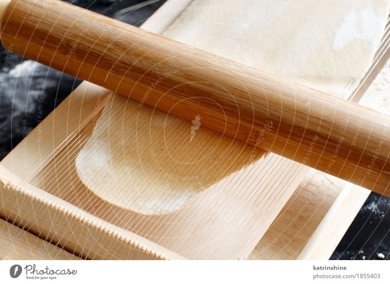 Making spaghetti alla chitarra with a tool Dough Baked goods Nutrition Italian Food Table Kitchen Tool Guitar Make Dark Fresh Tradition Ingredients manual