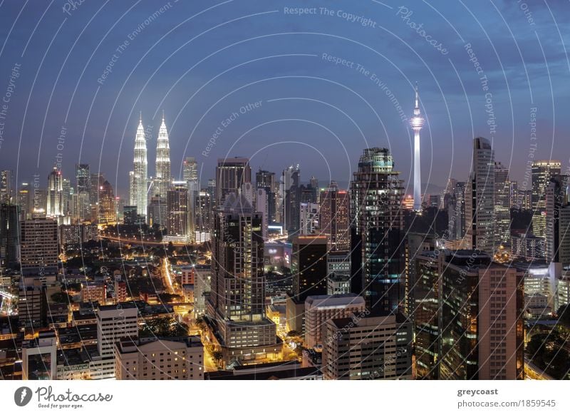 Night shot of Kuala. Panorama with city architecture and transport. Malaysia capital view with Petronas Towers and Menara Tower Town Capital city