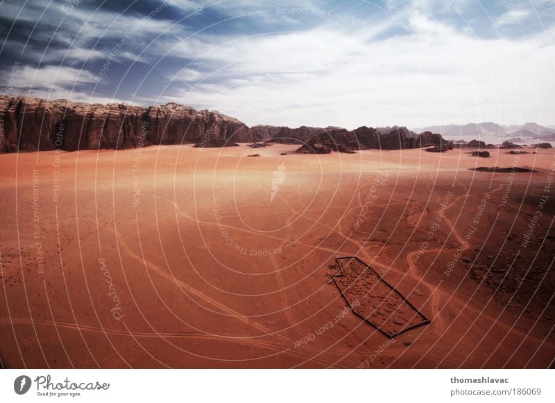 Wadi Rum desert Environment Nature Landscape Sand Sky Clouds Beautiful weather Warmth Hill Rock Mountain Desert Vacation & Travel Cemetery Red Colour photo