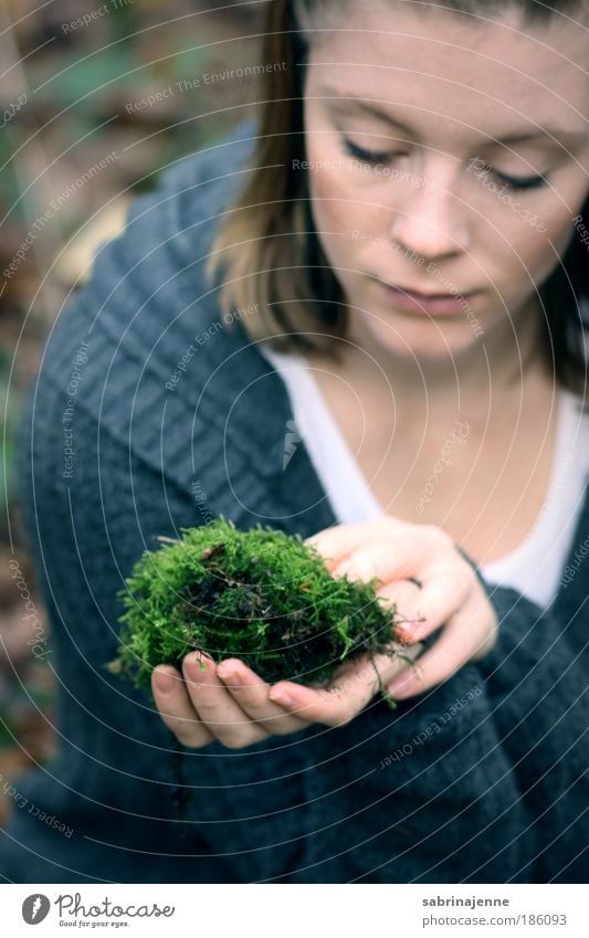 a piece of green Human being Feminine Young woman Youth (Young adults) Hand 1 18 - 30 years Adults Moss Forest Jacket Blonde Blue Green Black Colour photo