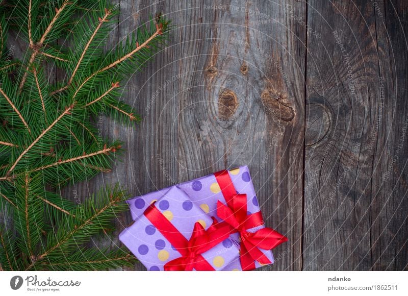 Gray wooden festive background with branches of spruce Winter Decoration New Year's Eve Tree Wood String Green Red Surprise Tradition board christmas December