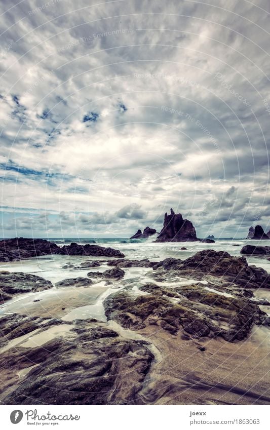 Stones and paths Far-off places Waves Nature Landscape Sky Clouds Beautiful weather Rock Coast Beach Island Tenerife Spain Esthetic Threat Infinity Blue Brown