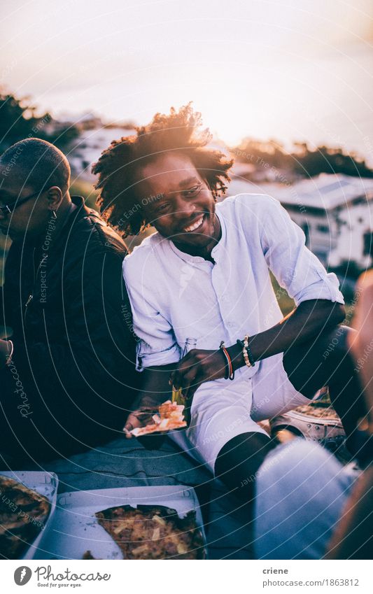 Young mixed race group of friends having pizza picnic in sunset Eating Dinner Fast food Lifestyle Joy Freedom Party Going out Young man Youth (Young adults)