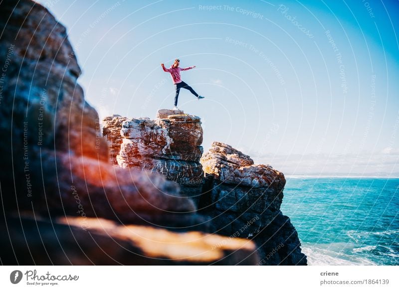 Young Man Balancing on cliff by the ocean Lifestyle Joy Vacation & Travel Tourism Trip Adventure Freedom Summer Summer vacation Beach Ocean Island Waves