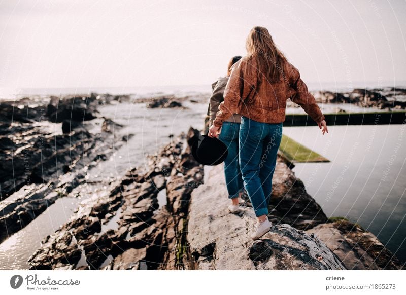 Tennager girls balancing on rocks on the beach Lifestyle Joy Beautiful Relaxation Vacation & Travel Tourism Trip Adventure Freedom Beach Ocean Waves Young woman