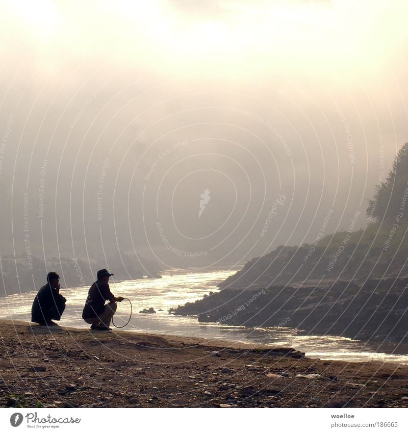 Mekong Melancholy Human being Masculine 2 Nature Landscape Water Clouds Fog Rock River bank Pak Beng Laos Asia South East Asia Flip-flops Cap Sand Observe