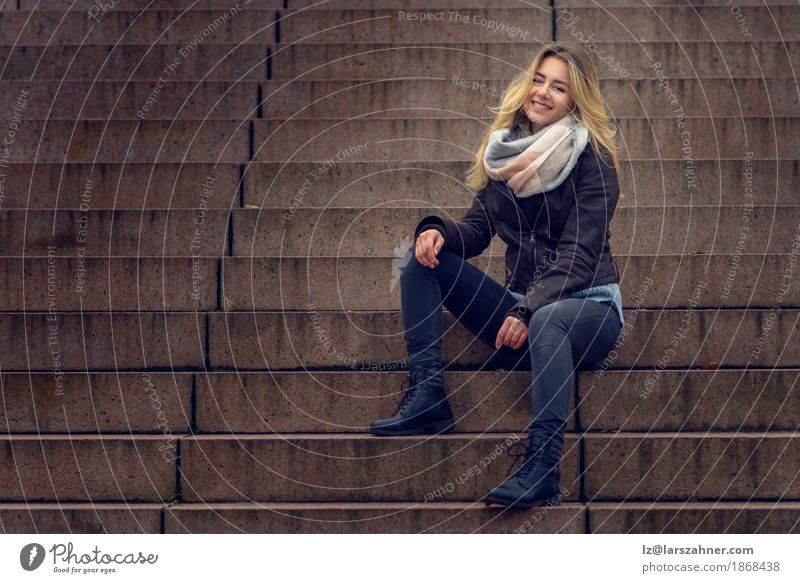 Smiling stylish woman sitting on a flight of concrete steps Style Happy Face Relaxation Business Woman Adults Fashion Suit Scarf Brunette Sit Dark Happiness