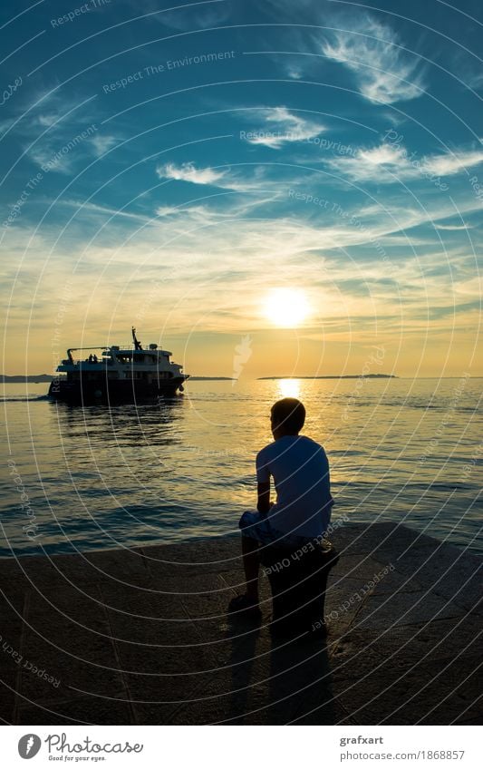 Boy on jetty observes departing ship at sunset Evening Depart Loneliness Twilight Sadness Emotions Ferry Wanderlust Peaceful Boy (child) Coast Picturesque Ocean