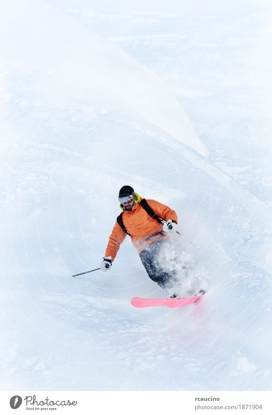 Young male freeride skier making a turn in powder snow Winter Snow Mountain Sports Skiing Man Adults White Caucasian Ski-run Extreme freerider ice one orange