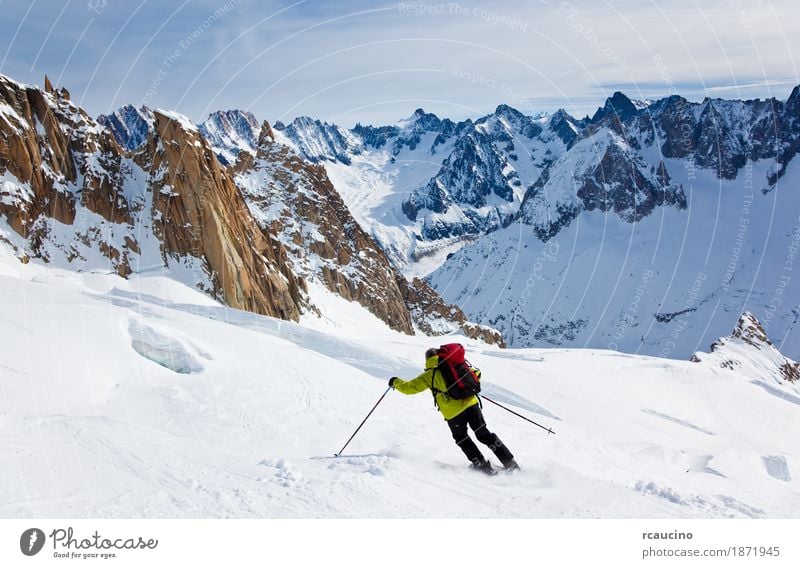 Male skier moving down in snow powder Joy Adventure Winter Snow Mountain Sports Skiing Man Adults Landscape Sky Glacier Green Clear sky Extreme freeride