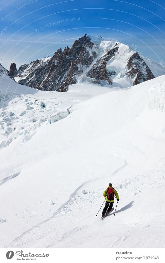 Male skier moving down in snow powder Joy Adventure Winter Snow Mountain Sports Skiing Man Adults Landscape Sky Glacier Green Clear sky Extreme freeride