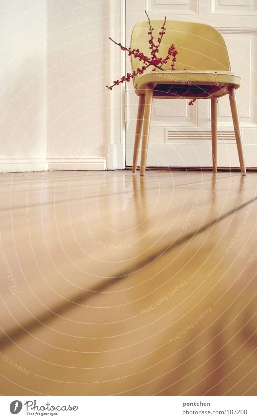 A yellow vintage chair is standing in a room of an old building flat on the floor of a Lifestyle Elegant Style Design Living or residing Flat (apartment)