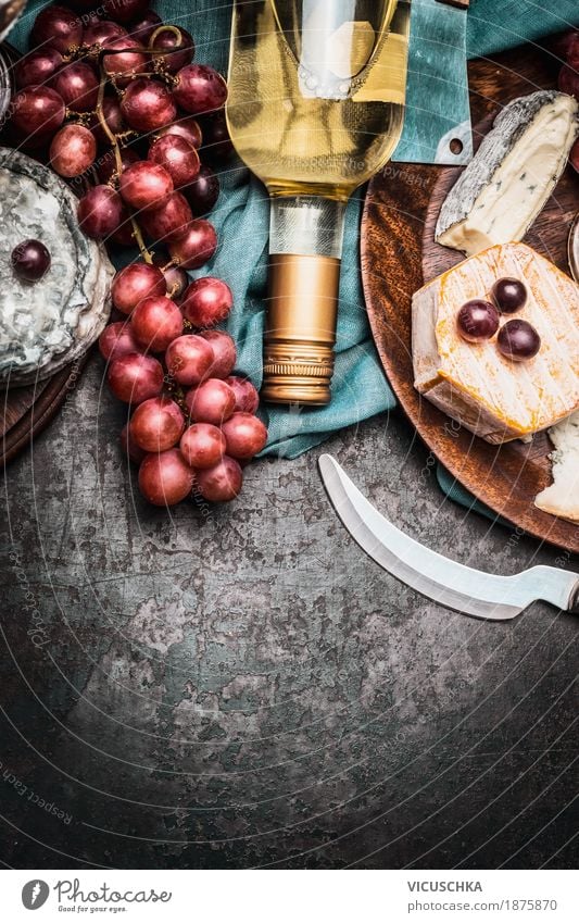 Cheese with wine and grapes Food Dairy Products Fruit Nutrition Banquet Beverage Wine Knives Style Design Table Party Event Restaurant Yellow Brie bottle Snack