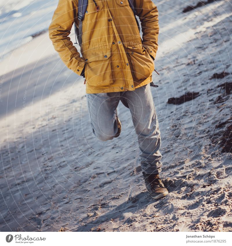 Man with winer jacket on the beach stands on one leg on the beach in Binz Human being Masculine Body Legs 1 18 - 30 years Youth (Young adults) Adults Esthetic