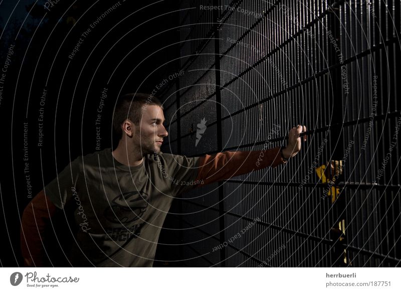 Sports field at night Martial arts Football pitch Human being Masculine Young man Youth (Young adults) Adults Face 1 18 - 30 years Green Black Grating Lean Wait