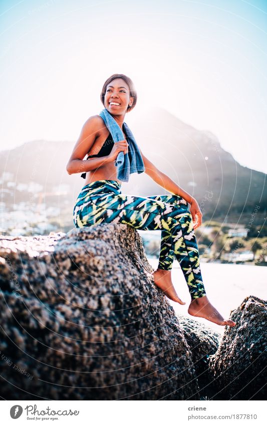 Mixed Race female athlete resting after workout at the beach Lifestyle Joy Well-being Relaxation Swimming & Bathing Leisure and hobbies Summer Sunbathing Beach