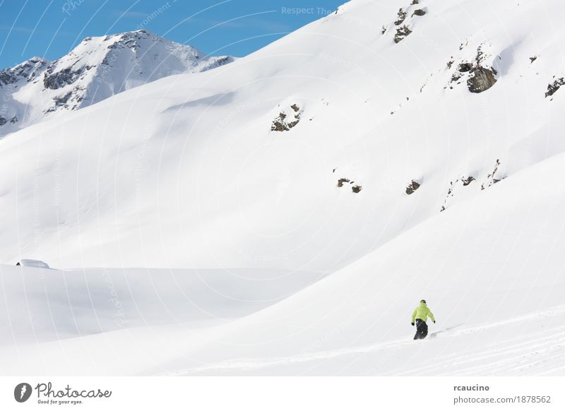 Snowboarder goes downhill over a snowy mountain landscape. Vacation & Travel Winter Mountain Sports Boy (child) Sky Alps Freeze Speed cold Extreme Resort