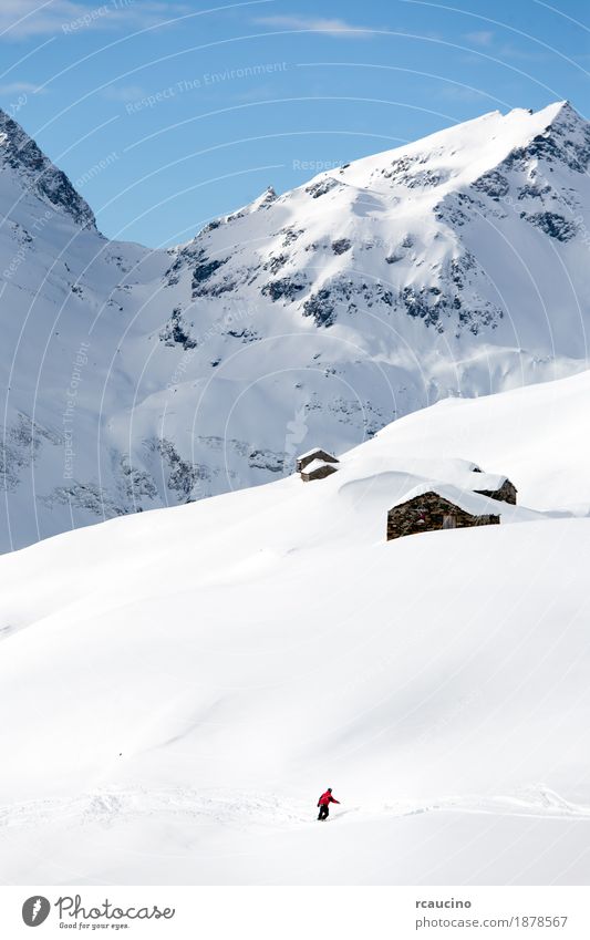 Snowboarder goes downhill over a snowy mountain landscape Vacation & Travel Winter Mountain Sports Skiing Boy (child) Man Adults Nature Landscape Sky Alps