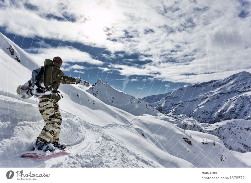 Snowboarder goes downhill over a snowy mountain landscape. Vacation & Travel Winter Mountain Sports Skiing Boy (child) Man Adults Nature Landscape Sky Alps