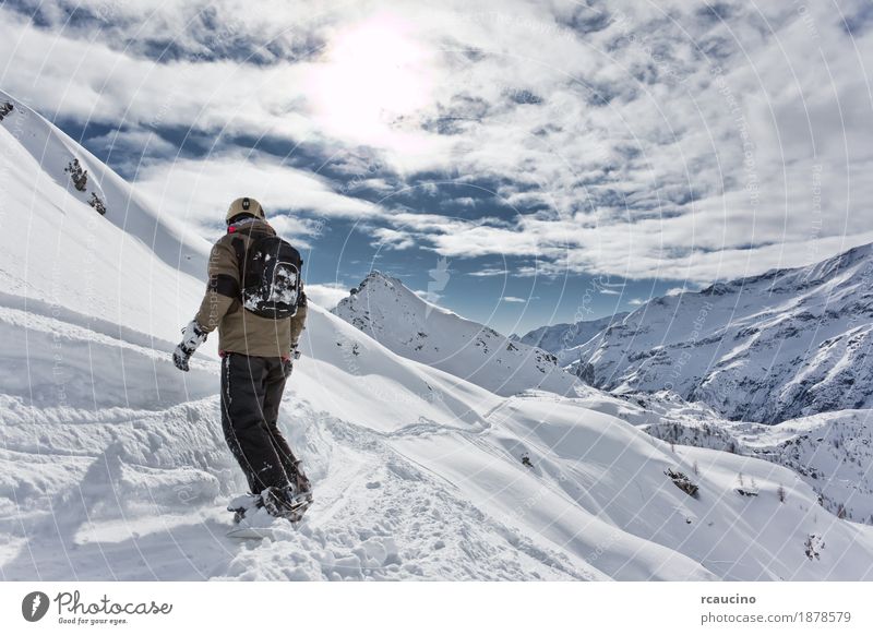 Snowboarder goes downhill over a snowy mountain landscape. Vacation & Travel Winter Mountain Sports Skiing Boy (child) Landscape Sky Alps Freeze Speed Clear sky