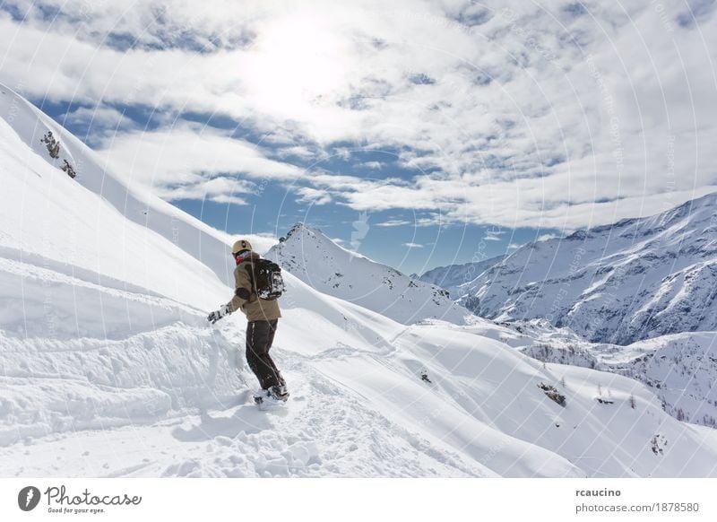 Snowboarder goes downhill over a snowy mountain landscape Vacation & Travel Winter Mountain Sports Skiing Boy (child) Landscape Sky Alps Freeze Speed cloudscape