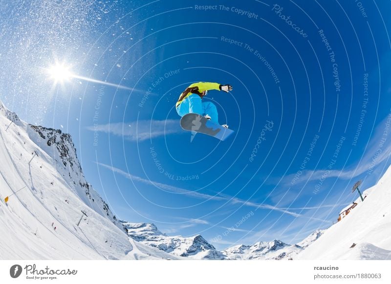 Snowboarder launching off a jump Joy Vacation & Travel Sun Winter Mountain Sports Boy (child) Man Adults Alps Jump Cool (slang) Dangerous cold Extreme fast Guy