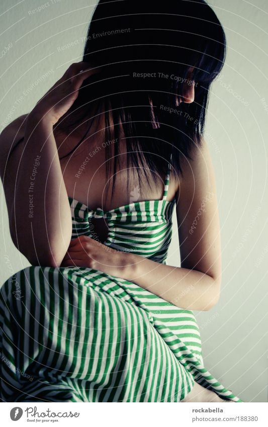 Dark-haired woman with dress Feminine Esthetic Uniqueness Emotions Moody Sadness Calm Sit Looking away Loneliness Upper body Front view Profile Black-haired