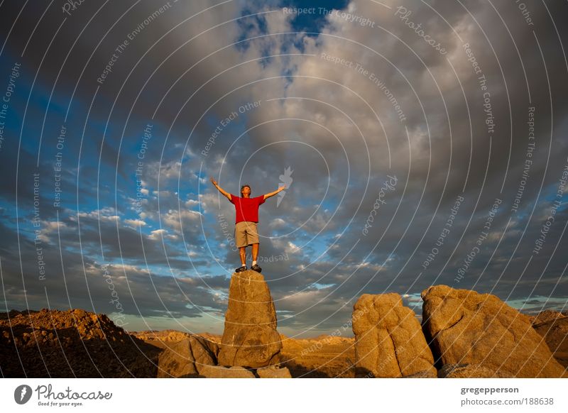 Rock climber on the summit. Joy Life Adventure Climbing Mountaineering Success Man Adults 1 Human being Nature Landscape Sky Storm clouds Peak Hiking boots