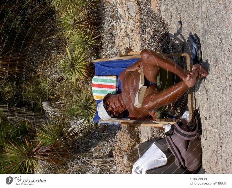 Old man in a deckchair Man Spain South Senior citizen Light Style Places Free space Superior Naked Sunburn Sunbathing Couch Deckchair Progress Brown Cap Towel