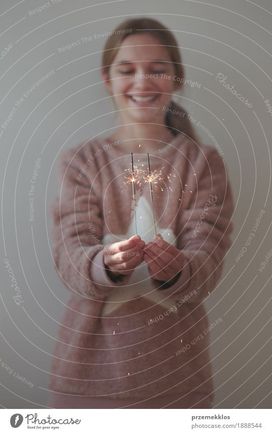 Young smiling girl celebrating New Year holding sparklers Lifestyle Joy Happy Feasts & Celebrations Christmas & Advent New Year's Eve Human being Girl