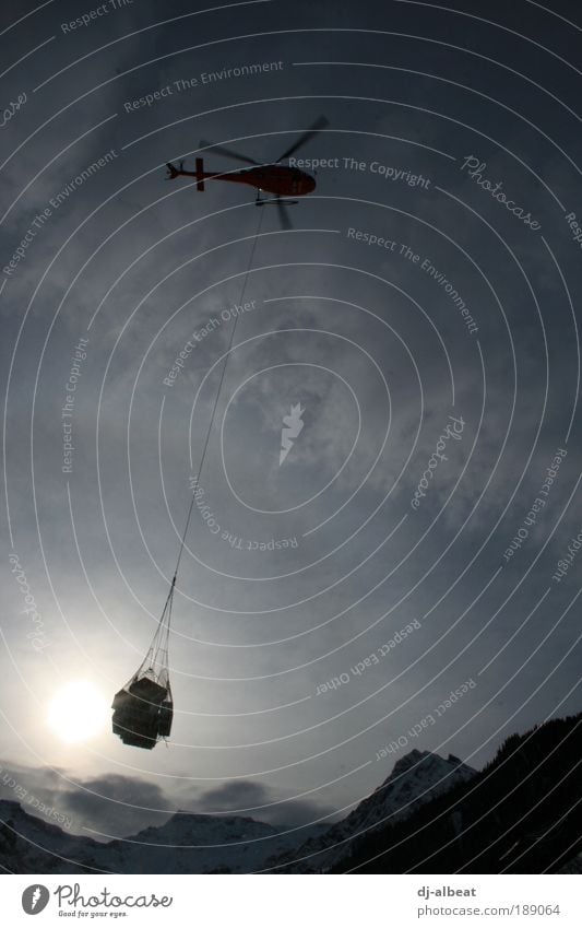 carry me home Landscape Sky Clouds Sunlight Winter Alps Transport Aviation Helicopter Rotate Flying Blue Black Silver Power Mountain Logistics Exterior shot