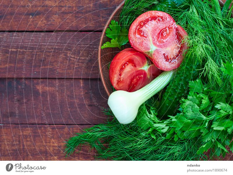 Vegetables salad with dill and onion in an earthenware dish Food Nutrition Eating Vegetarian diet Diet Crockery Leaf Wood Above Brown Green Red cooking cucumber