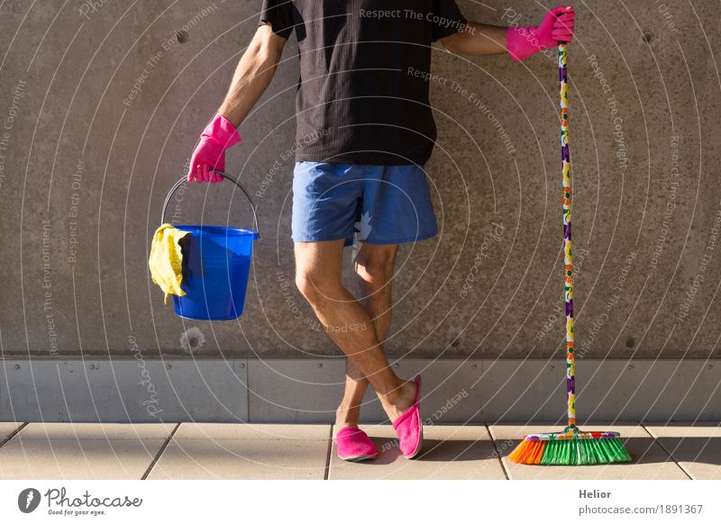 A househusband in pink slippers and cleaning utensils Summer Masculine Man Adults Body 1 Human being 30 - 45 years Wall (barrier) Wall (building) Slippers Broom