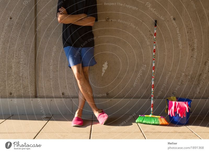 A househusband in pink slippers and cleaning utensils Summer Masculine Man Adults Body 1 Human being 30 - 45 years Wall (barrier) Wall (building) T-shirt