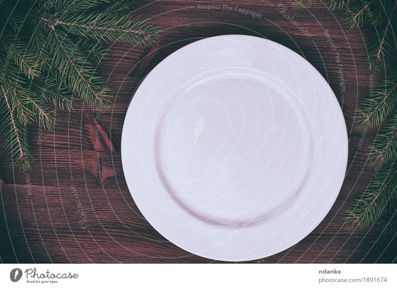 White empty plate with a green branch of spruce Dinner Crockery Plate Table Kitchen Christmas & Advent New Year's Eve Tree Wood Above Retro background Blank