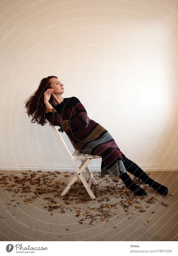 woman sitting in room with autumn leaves Chair Room Feminine 1 Human being Leaf Dress Brunette Long-haired Observe Think Looking Sit pretty Contentment