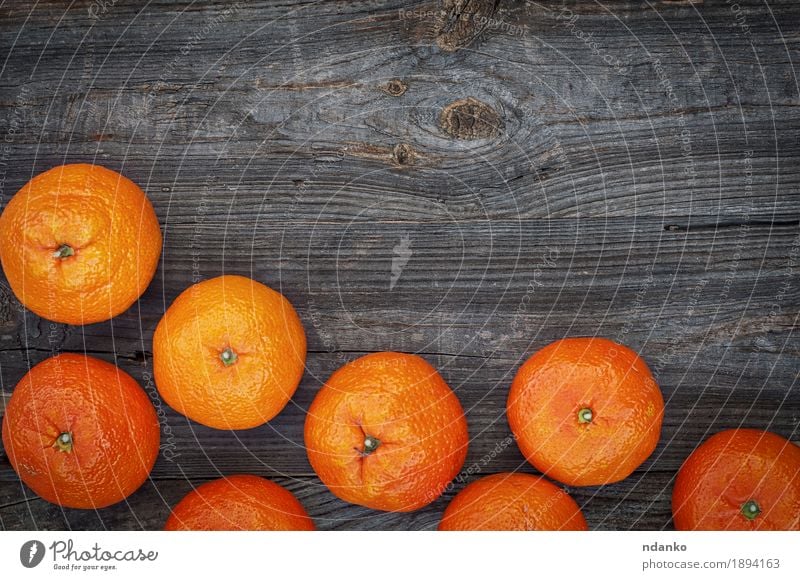 Ripe orange mandarins on the gray wooden background Fruit Dessert Eating Vegetarian diet Diet Table Group Nature Autumn Wood Old Fresh Large Natural Juicy Gray